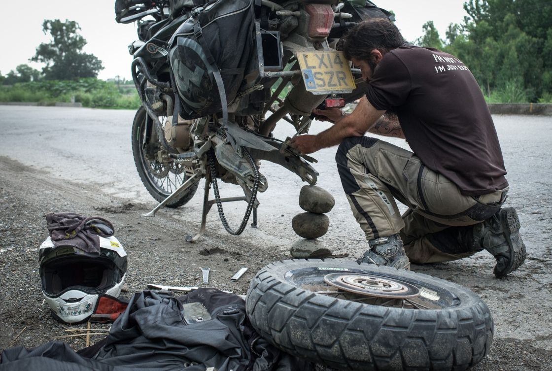 Punjab, India – after discovering I’d scraped through my rear brake pads, I’d had to get to work at the side of the road. This is the grin of happiness after fitting new pads in the hot, stinky, sweaty weather!