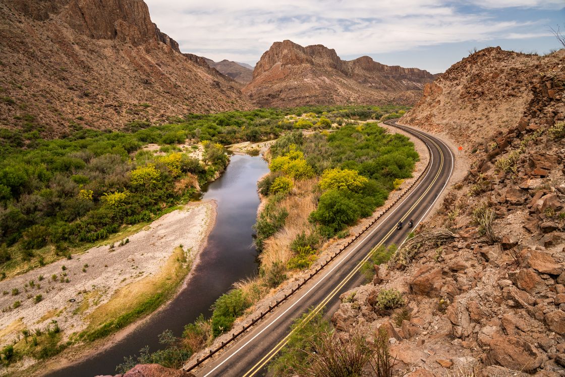 Robert Baldinger and Dave “Texas-Dave” Hunninghake cruise along the 170 road with the Mexican border to the left