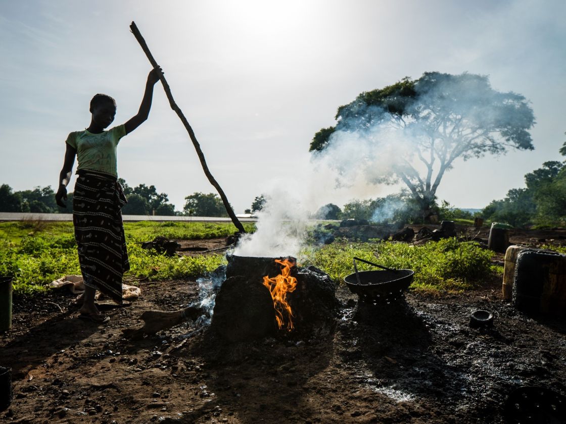  Roasting cashews on the side of the road as we passed into Burkina Faso.