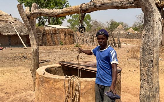 A young man getting water from the well. He told me he helped digging the well by hand.