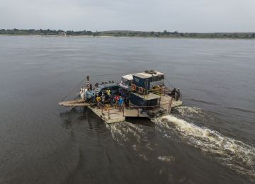 A small vessel across a big river.