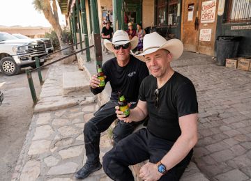 Two cowboys at the Starlight theatre porch singing along with the crowd.